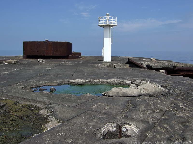 Upper deck view looking towards the bow - rear of the two 14 inch gun turrets. A modern navigation beacon sits on top the white tower.